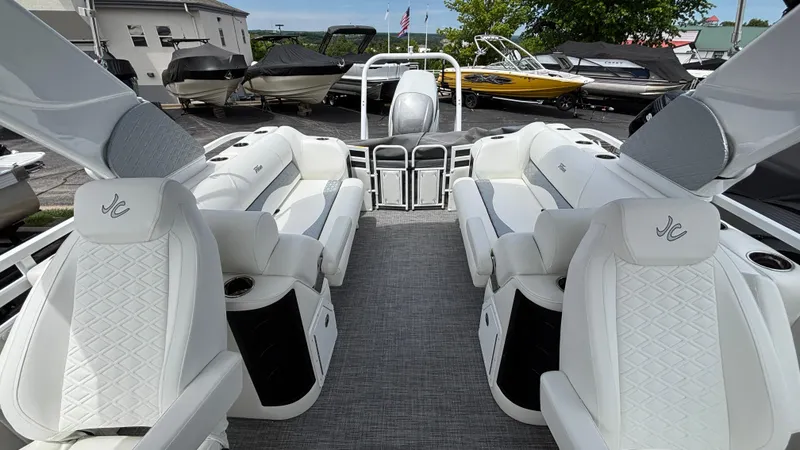 Slide: The Image of 2025 JC Sporttoon 27TT boat interior with luxurious white seating and modern design. - 11
