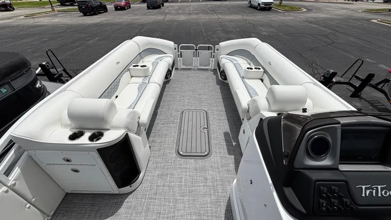 Slide: The Image of 2025 JC Sporttoon 27TT pontoon boat interior with white seating and modern dashboard. - 2
