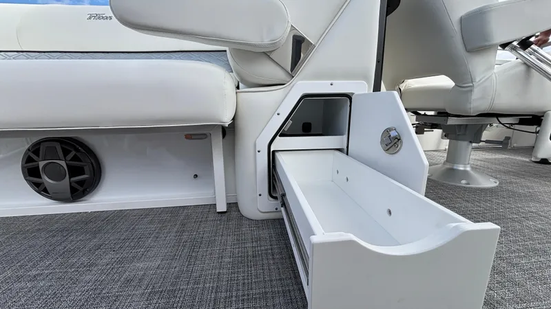 Slide: The Image of Interior of 2025 JC Sporttoon 27TT boat with open storage drawer and seating. - 20