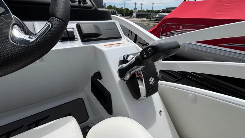 Slide: The Image of Control panel of 2025 JC Sporttoon 27TT boat with steering wheel and throttle lever. - 23