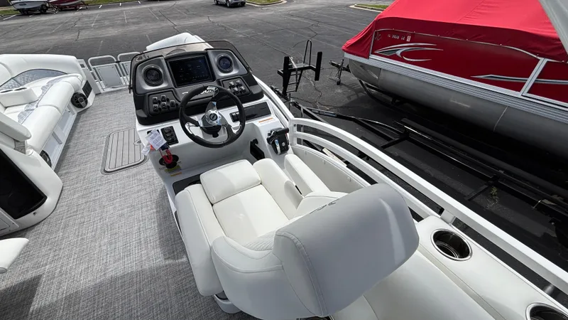 Slide: The Image of 2025 JC Sporttoon 27TT boat interior with modern dashboard and comfortable seating. - 24