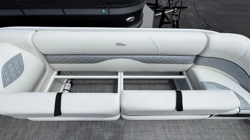 Slide: The Image of 2025 JC Sporttoon 27TT boat seating with white and gray upholstery, open storage compartments. - 25