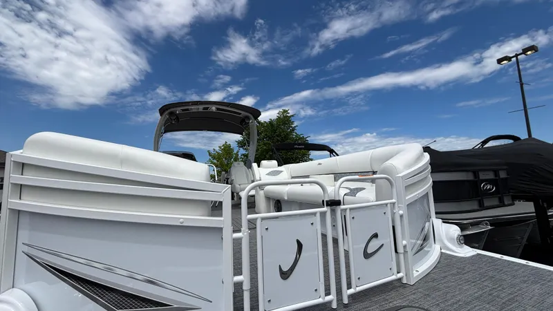 Slide: The Image of 2025 JC Sporttoon 27TT pontoon boat under a clear blue sky. - 30