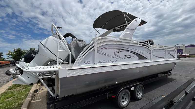 Slide: The Image of 2025 JC Sporttoon 27TT pontoon boat on trailer under cloudy sky. - 9