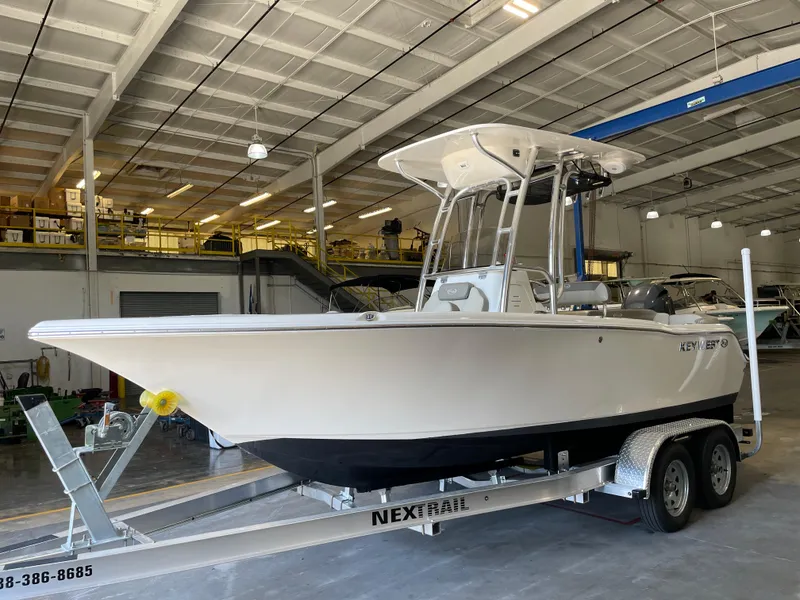 Slide: The Image of 2023 Key West 203 FS boat on trailer in indoor storage facility. - 1