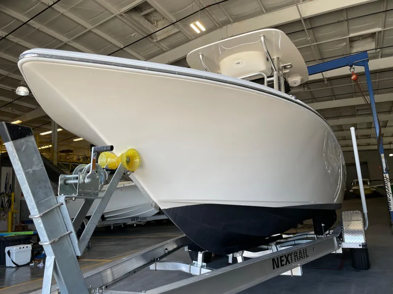 Slide: The Image of 2023 Key West 203 FS boat with Yamaha 150 engine in a warehouse. - 10