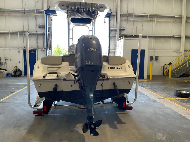 Slide: The Image of 2023 Key West 203 FS boat with Yamaha outboard motor in a garage setting. - 11