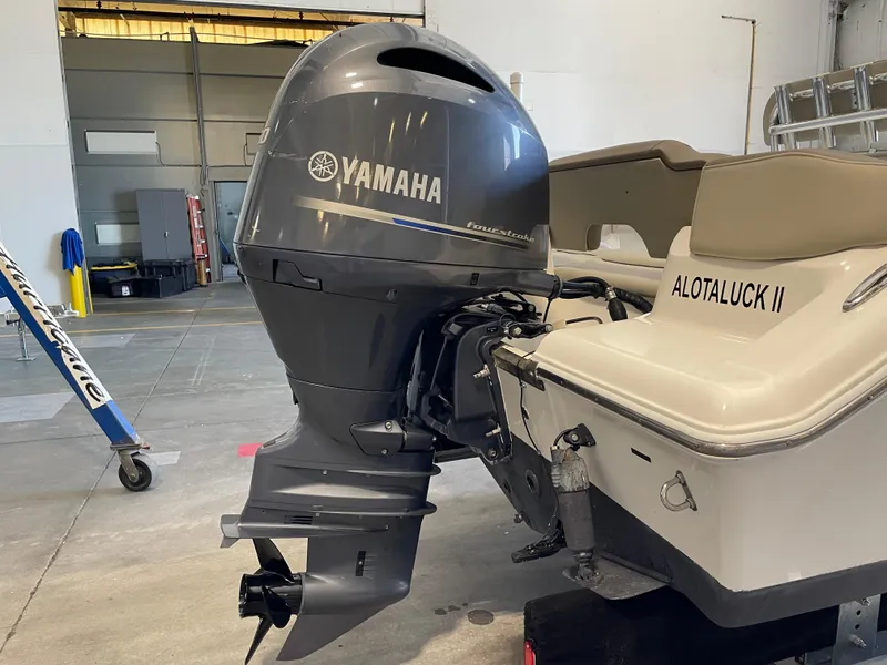 Slide: The Image of 2023 Key West 203 FS boat with Yamaha outboard motor in a showroom. - 14