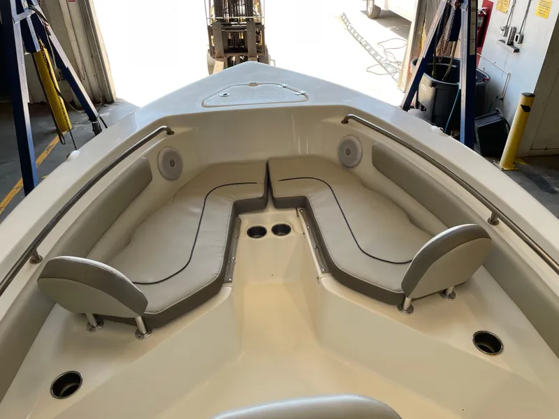 Slide: The Image of 2023 Key West 203 FS boat interior with cushioned seating and cup holders. - 19