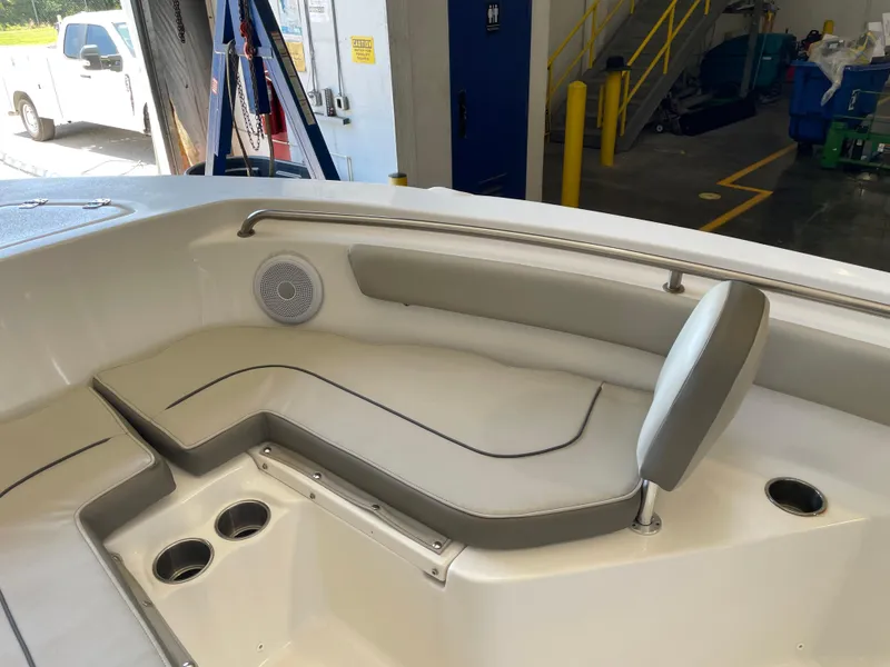 Slide: The Image of 2023 Key West 203 FS boat interior with cushioned seating and cup holders. - 20