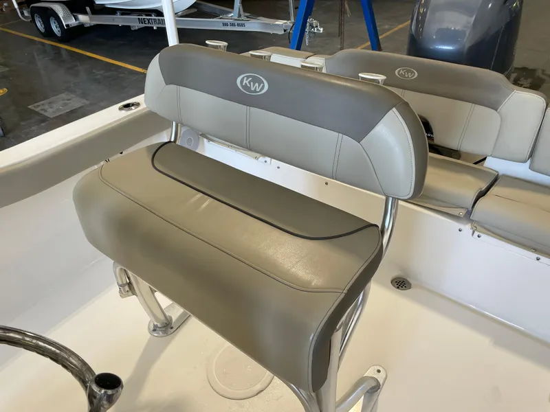 Slide: The Image of 2023 Key West 203 FS boat console with steering wheel, gauges, and controls. - 26