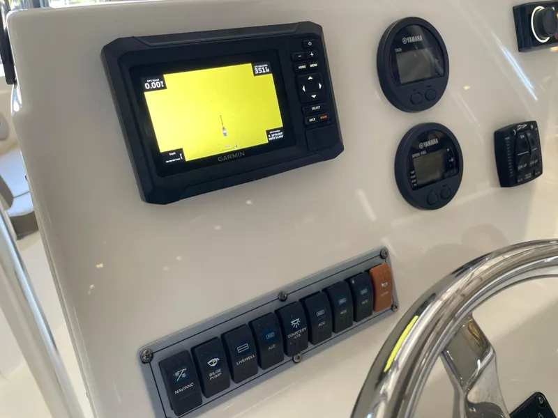 Slide: The Image of Control panel of a 2023 Key West 203 FS boat with radio and switches. - 28