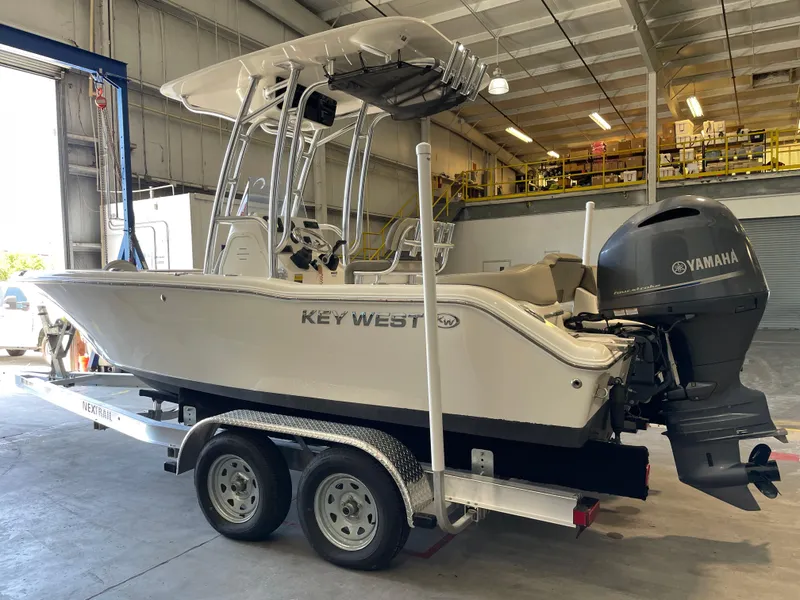 Slide: The Image of 2023 Key West 203 FS boat on trailer in a warehouse setting. - 3