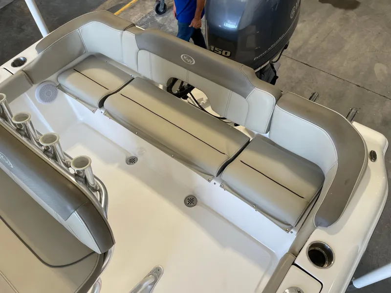 Slide: The Image of 2023 Key West 203 FS boat interior with seating and motor in a garage setting. - 33