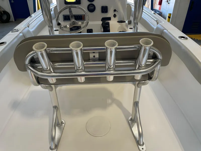 Slide: The Image of 2023 Key West 203 FS boat T-top with rod holders in a warehouse setting. - 35