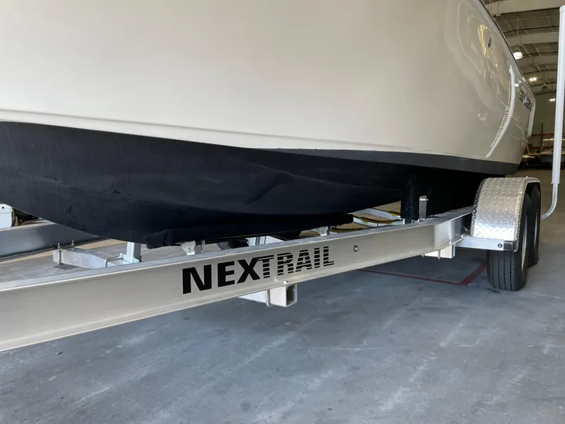 Slide: The Image of Trailer wheels of a 2023 Key West 203 FS boat, parked indoors. - 41