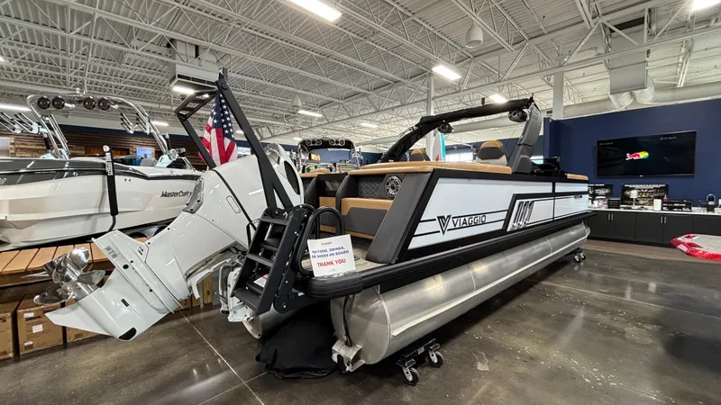 Slide: The Image of 2025 Viaggio Diamante D24UW A-T pontoon boat displayed in a showroom. - 2