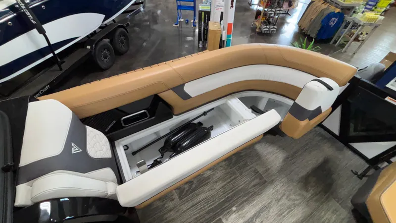Slide: The Image of 2025 Viaggio Diamante D24UW A-T boat interior with tan and white seating, storage compartment open. - 36