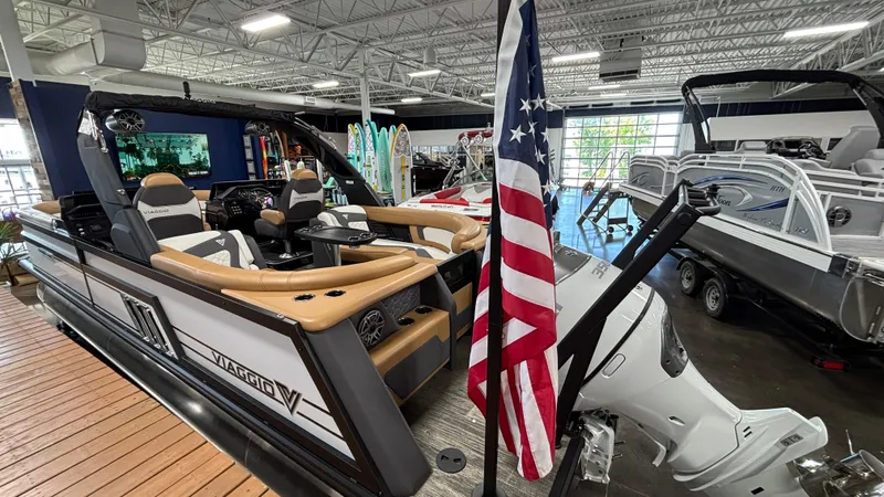 Slide: The Image of 2025 Viaggio Diamante D24UW A-T boat in showroom with American flag display. - 4