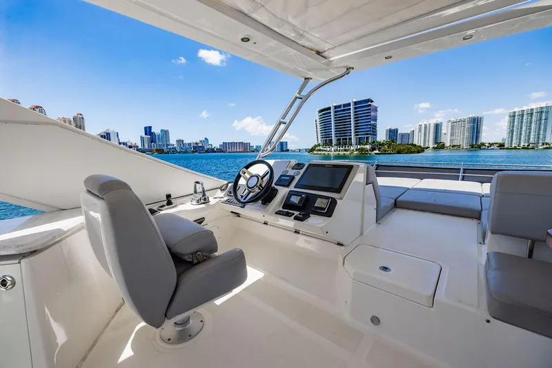 Slide: The Image of Flybridge of 2016 Sea Ray L650 Fly yacht with city skyline view. - 24