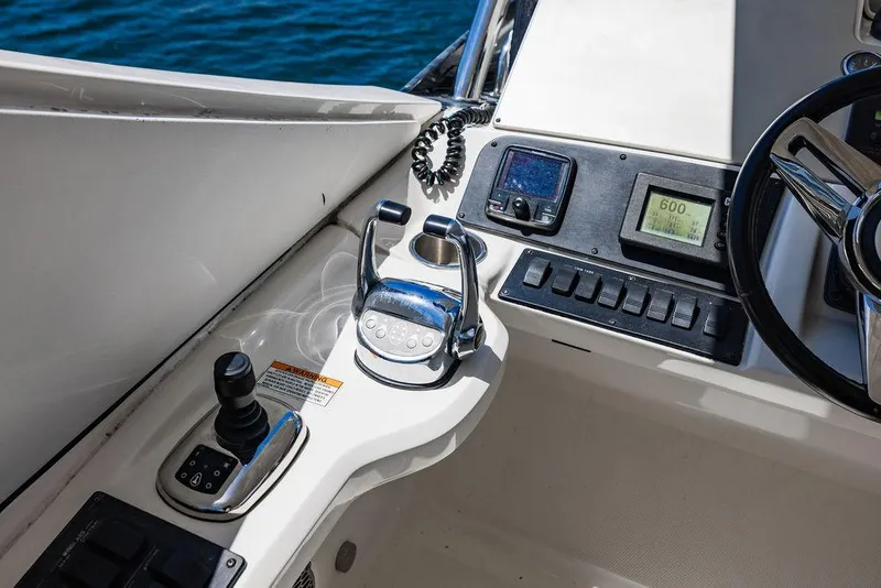 Slide: The Image of Control panel of 2016 Sea Ray L650 Fly yacht with steering wheel and navigation instruments. - 27
