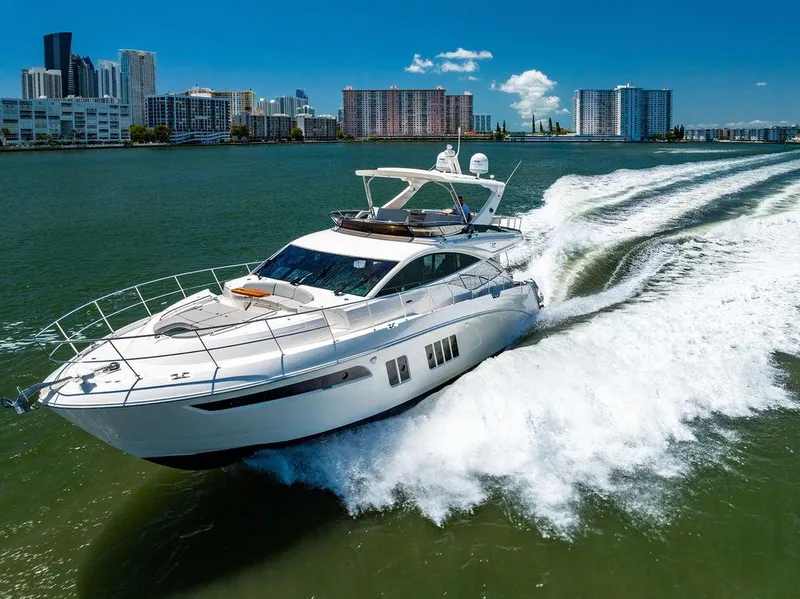 Slide: The Image of 2016 Sea Ray L650 Fly yacht cruising in a city waterfront setting. - 3