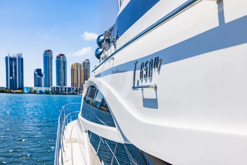 Slide: The Image of 2016 Sea Ray L650 Fly yacht with city skyline in the background. - 40
