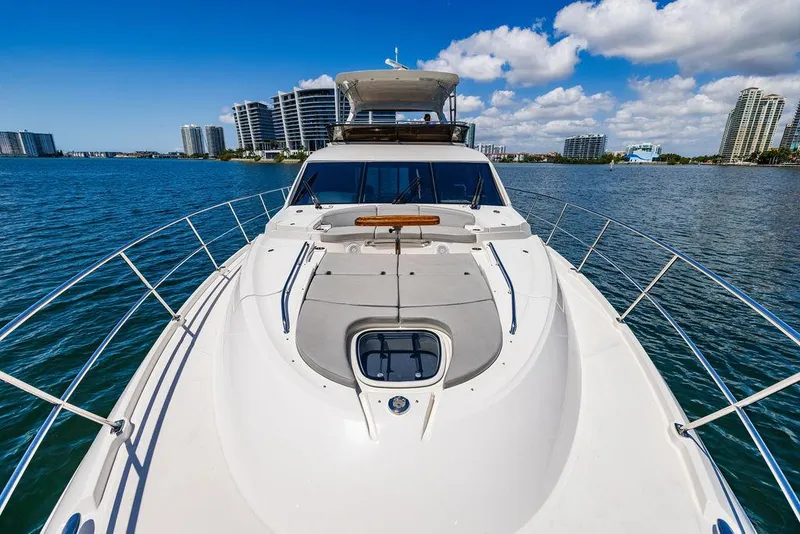 Slide: The Image of 2016 Sea Ray L650 Fly yacht on water, city skyline in background. - 44
