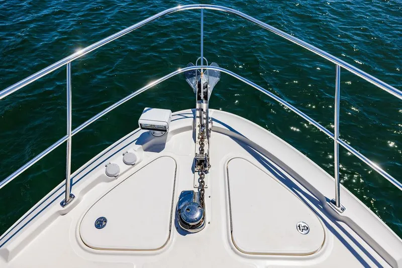 Slide: The Image of Bow of 2016 Sea Ray L650 Fly yacht with stainless steel railings on water. - 45