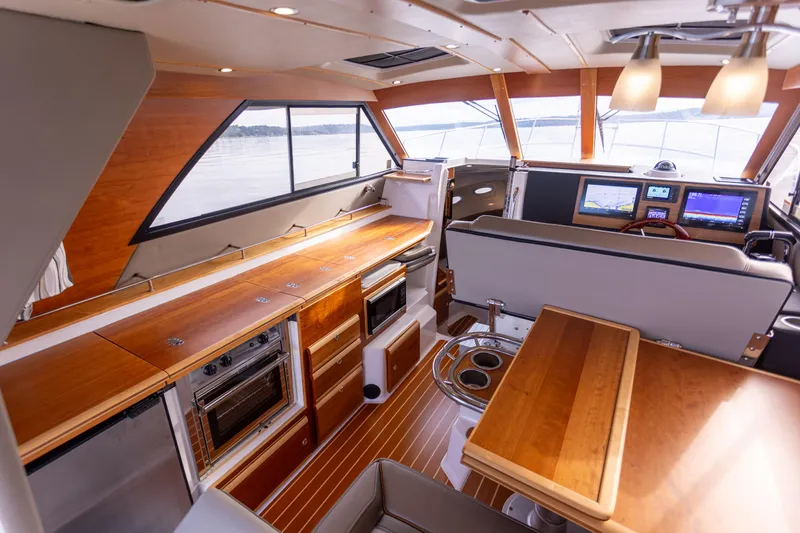 Slide: The Image of Interior of 2021 Cutwater C-32 CB yacht with modern kitchen and navigation area. - 15
