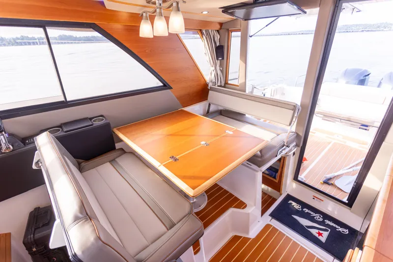Slide: The Image of Interior of 2021 Cutwater C-32 CB boat with elegant dining area and panoramic windows. - 16