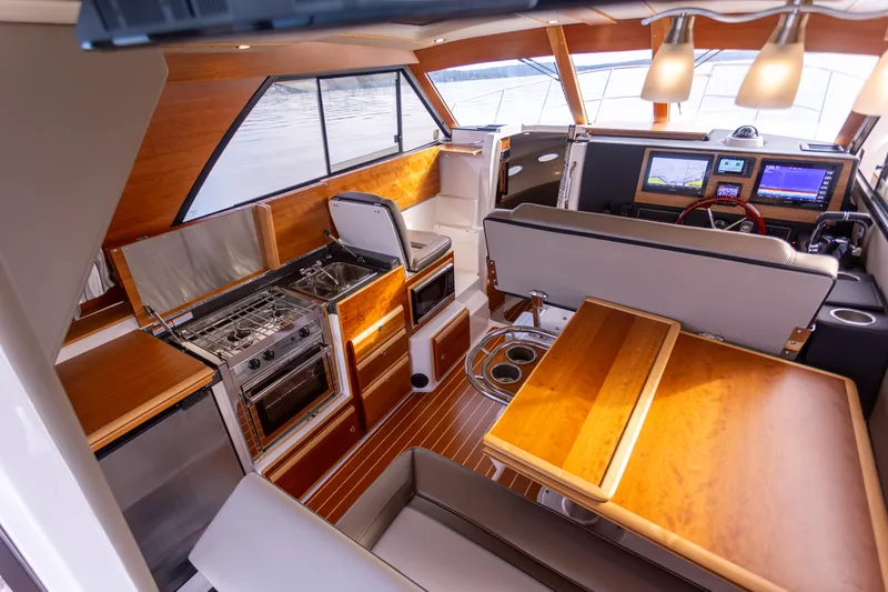 Slide: The Image of Interior of 2021 Cutwater C-32 CB boat with modern kitchen and seating area. - 17