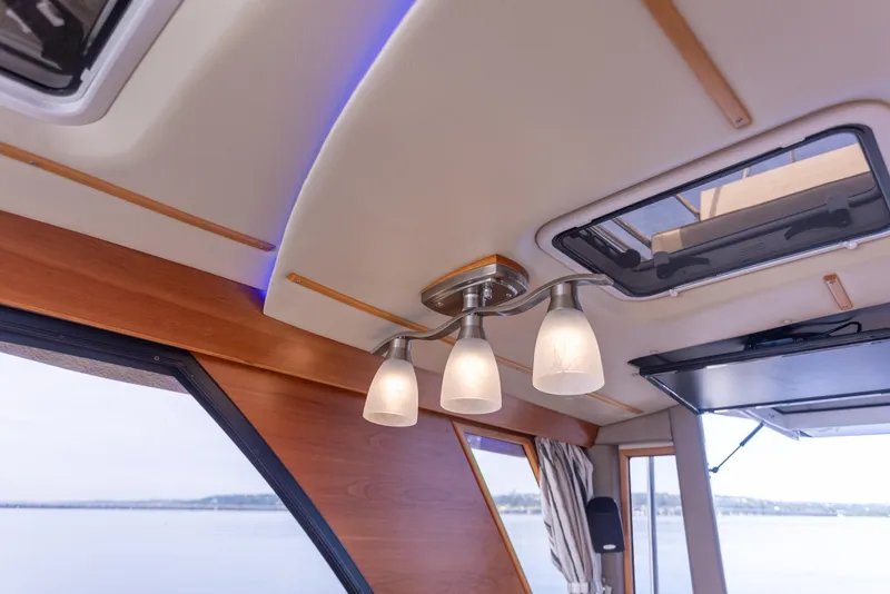 Slide: The Image of Interior view of 2021 Cutwater C-32 CB boat with modern ceiling lights. - 18