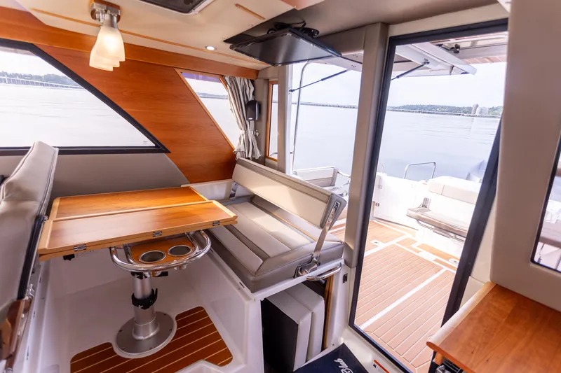 Slide: The Image of Interior of 2021 Cutwater C-32 CB boat with seating and table, overlooking water. - 20