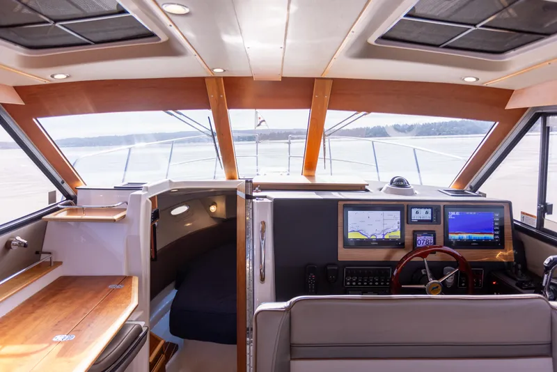 Slide: The Image of Interior of 2021 Cutwater C-32 CB boat with modern navigation equipment and wood accents. - 23