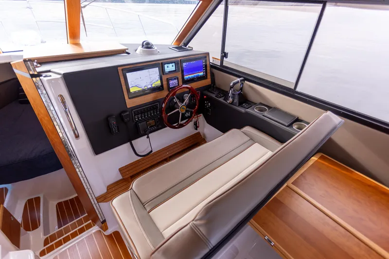 Slide: The Image of 2021 Cutwater C-32 CB helm with navigation screens and comfortable seating. - 24