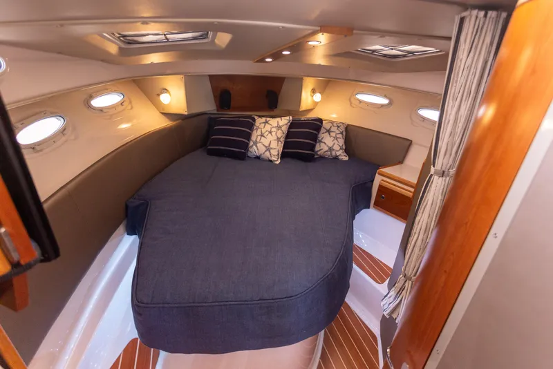 Slide: The Image of 2021 Cutwater C-32 CB cabin interior with cozy bed and ambient lighting. - 26