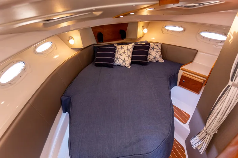 Slide: The Image of 2021 Cutwater C-32 CB cabin interior with cozy bed and ambient lighting. - 27