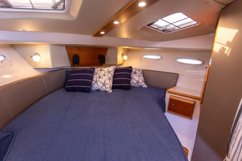 Slide: The Image of 2021 Cutwater C-32 CB cabin interior with cozy bed and ambient lighting. - 28