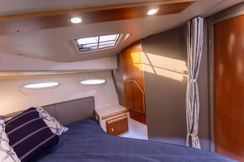 Slide: The Image of 2021 Cutwater C-32 CB cabin interior with bed, portholes, and skylight. - 30