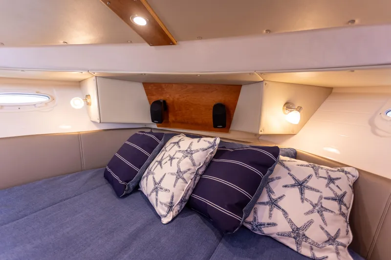 Slide: The Image of Cozy cabin interior of 2021 Cutwater C-32 CB with nautical-themed pillows. - 31