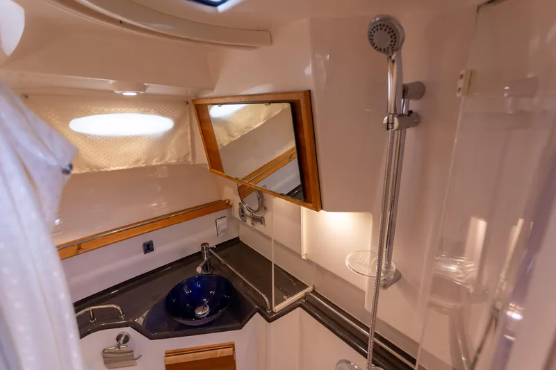 Slide: The Image of 2021 Cutwater C-32 CB boat bathroom with shower, sink, and mirror. - 34