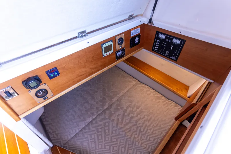 Slide: The Image of 2021 Cutwater C-32 CB cabin interior with control panel and cushioned sleeping area. - 35