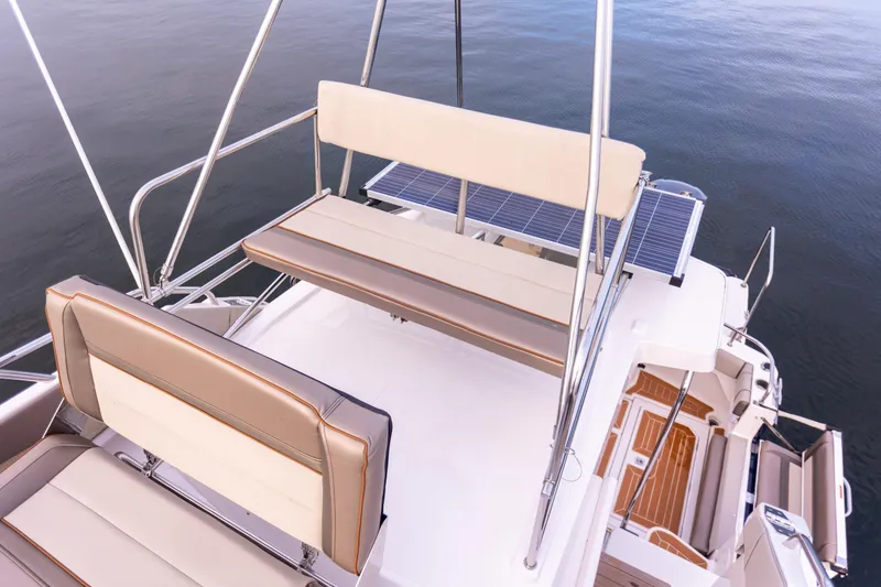Slide: The Image of 2021 Cutwater C-32 CB boat deck with seating and railing, overlooking calm water. - 37