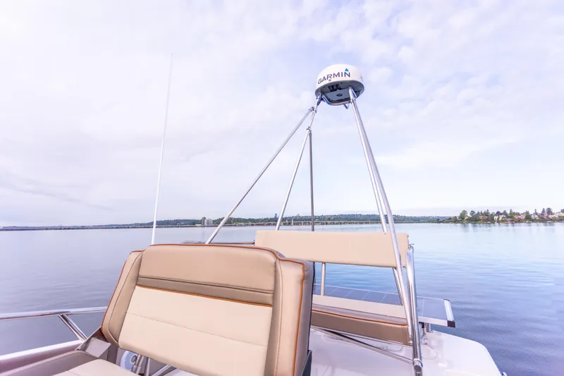 Slide: The Image of 2021 Cutwater C-32 CB boat with Garmin equipment on calm water under a cloudy sky. - 41
