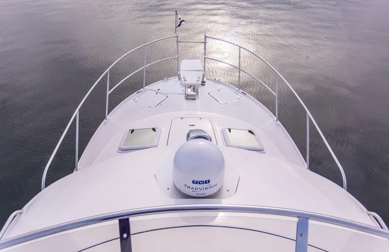 Slide: The Image of 2021 Cutwater C-32 CB boat bow view on calm water. - 42