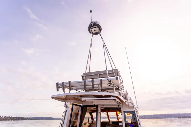 Slide: The Image of 2021 Cutwater C-32 CB boat on calm water under a pastel sky. - 44