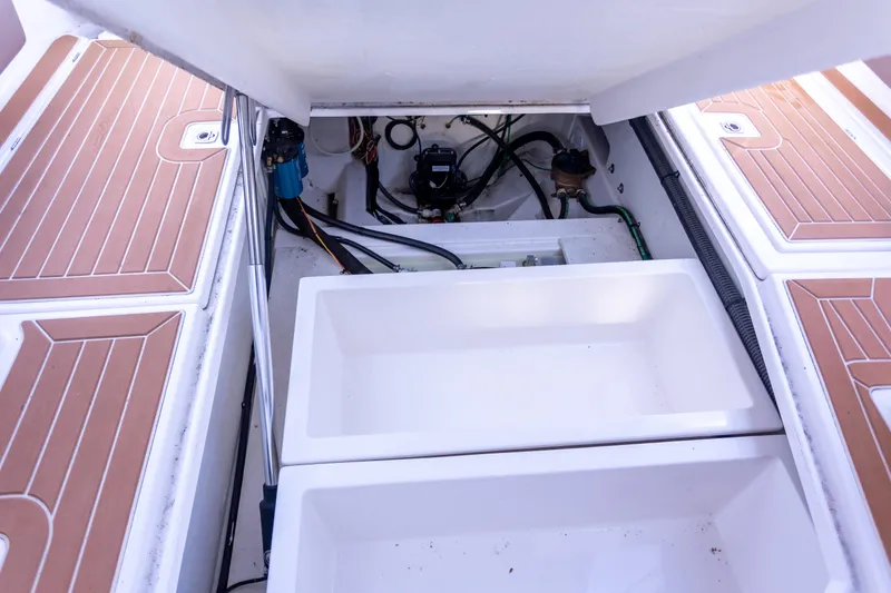 Slide: The Image of 2021 Cutwater C-32 CB boat storage compartment with open hatches and visible wiring. - 45