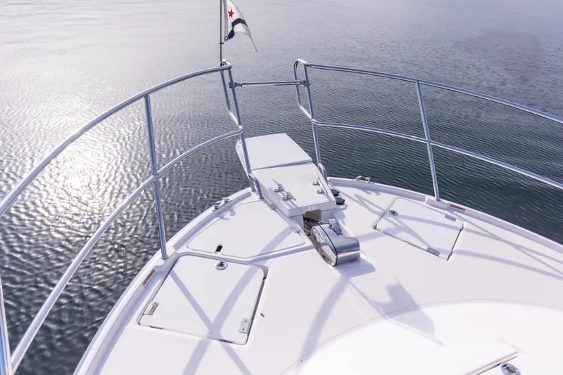 Slide: The Image of 2021 Cutwater C-32 CB boat bow with railing and calm water view. - 46