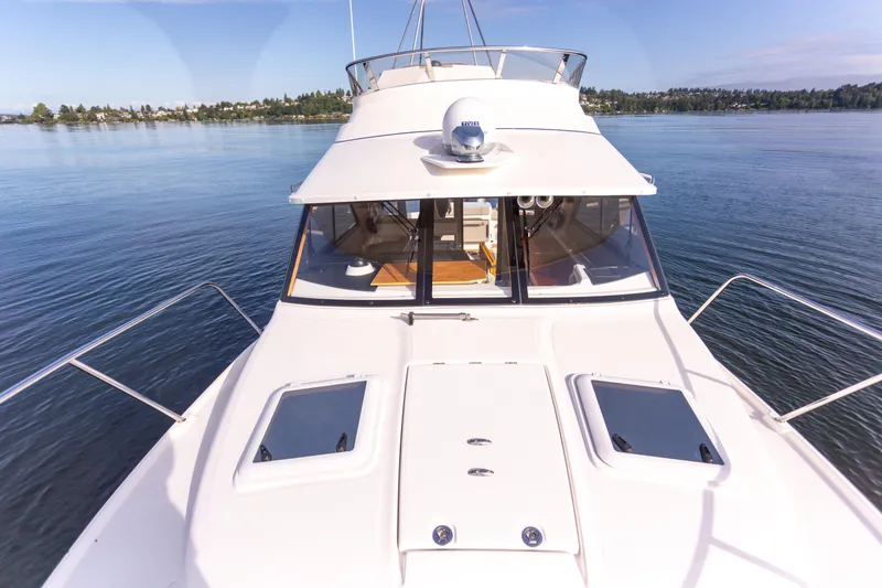 Slide: The Image of 2021 Cutwater C-32 CB yacht on calm water, showcasing sleek design and spacious deck. - 47
